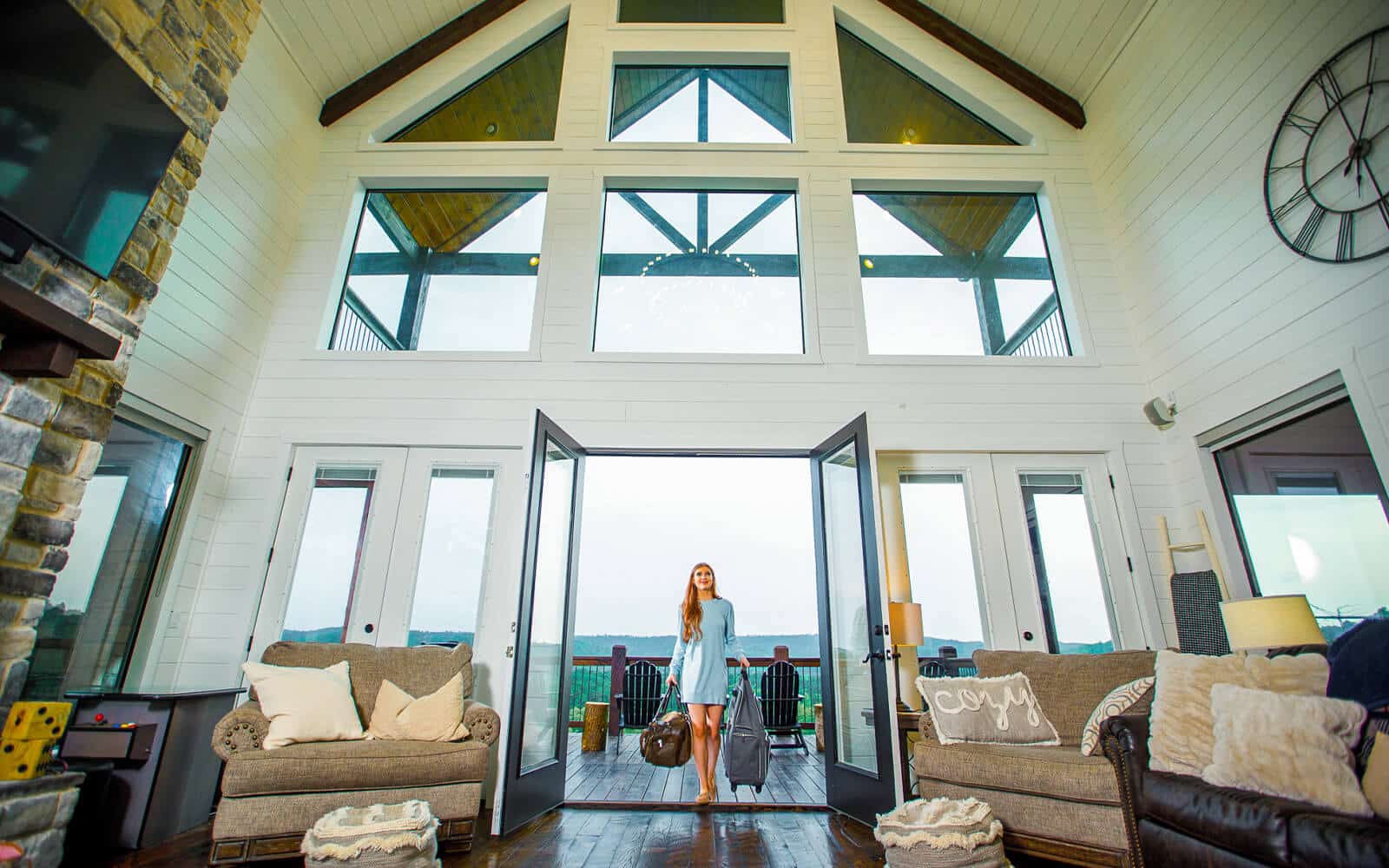 Woman with bags in luxury cabin in Beaver Bend Oklahoma