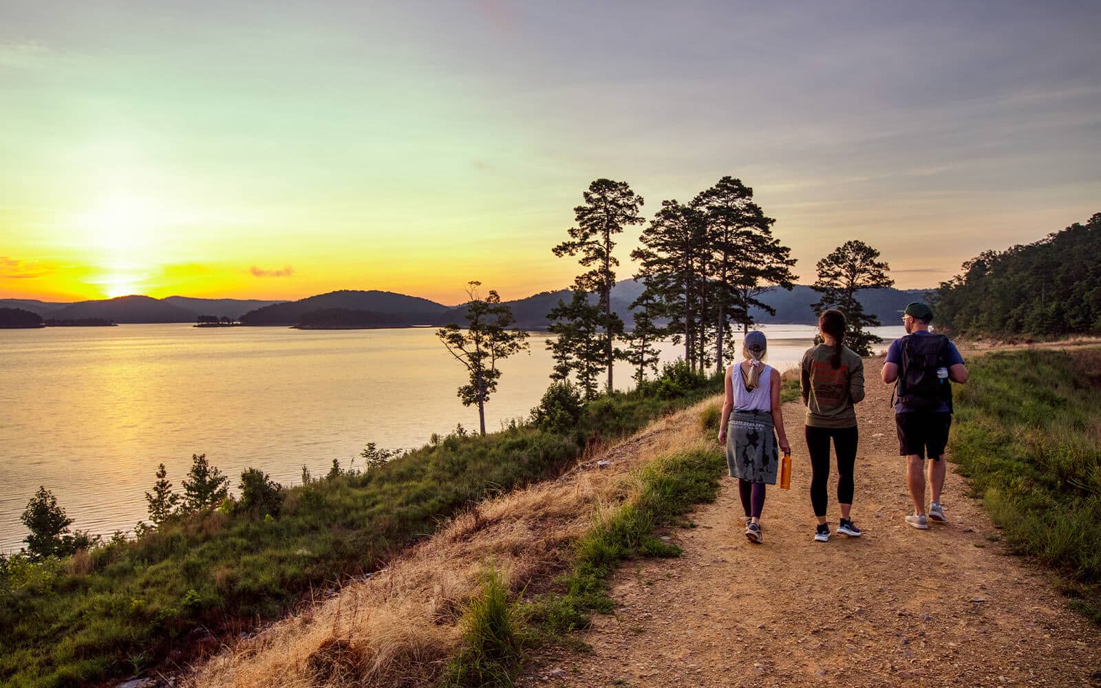Group hiking by Broken Bow Lake in Beavers Bend Cabin Country Oklahoma