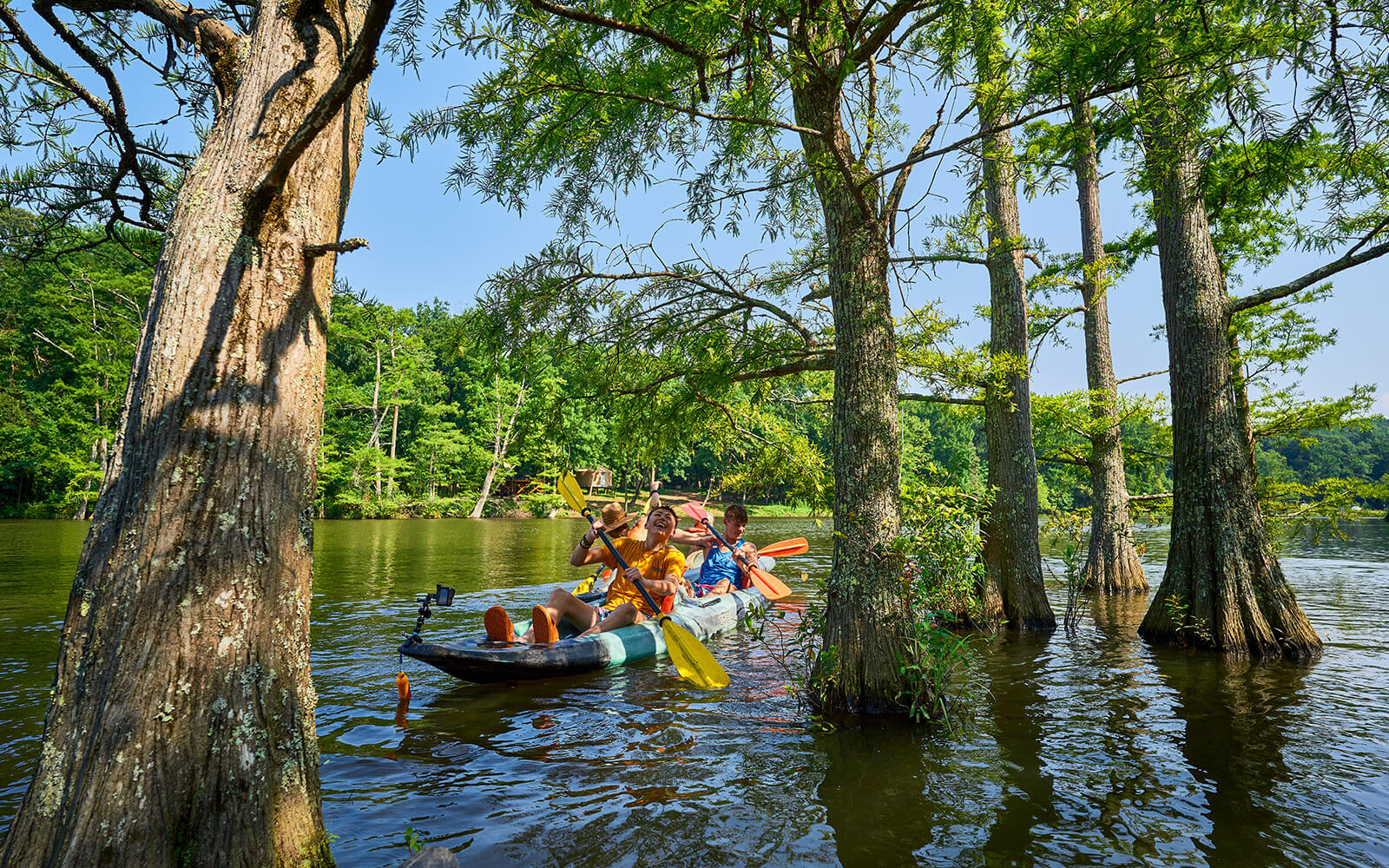 Group kayaking on Mountain Fork River in Oklahoma