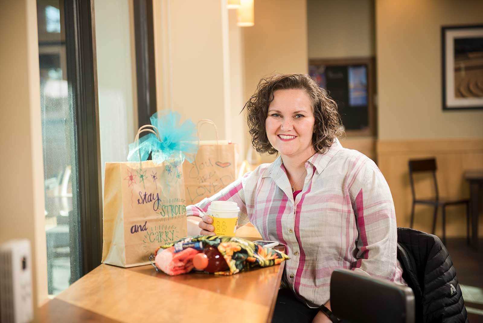 Shay Jones seated at counter with care package